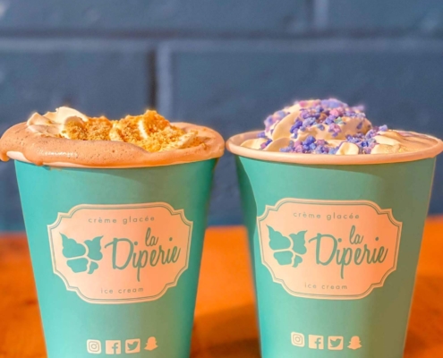 S’mores hot chocolate topped with Graham crumbs and white hot chocolate topped with cotton candy from La Diperie in Toronto