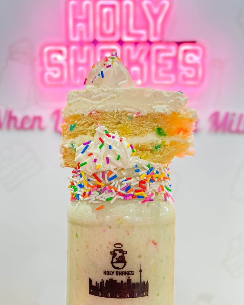 Holy Shakes Toronto Birthday Cake slice on top of Milkshake