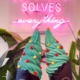 iHalo Krunch christmas themed ice cream with charcoal cones in front of Ice Cream Solves everything neon sign