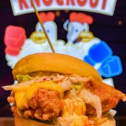Fried chicken sandwich with cheese oozing from Knockout Chicken in Toronto