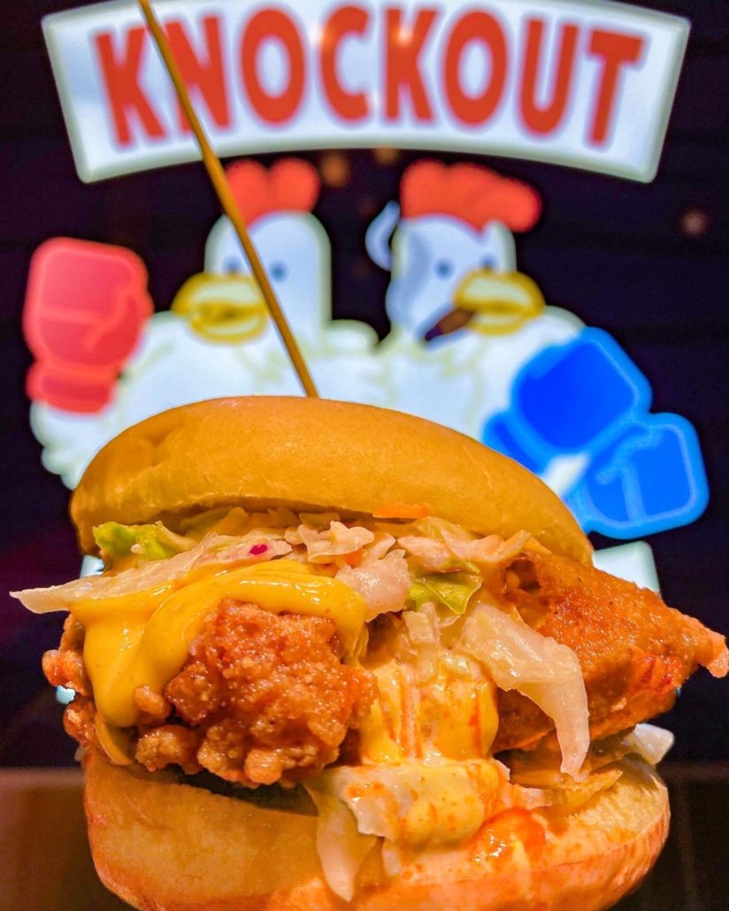 Fried chicken sandwich with cheese oozing from Knockout Chicken in Toronto