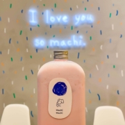 Machi Machi strawberry panna cotta bubble tea in front of I love you so machi sign