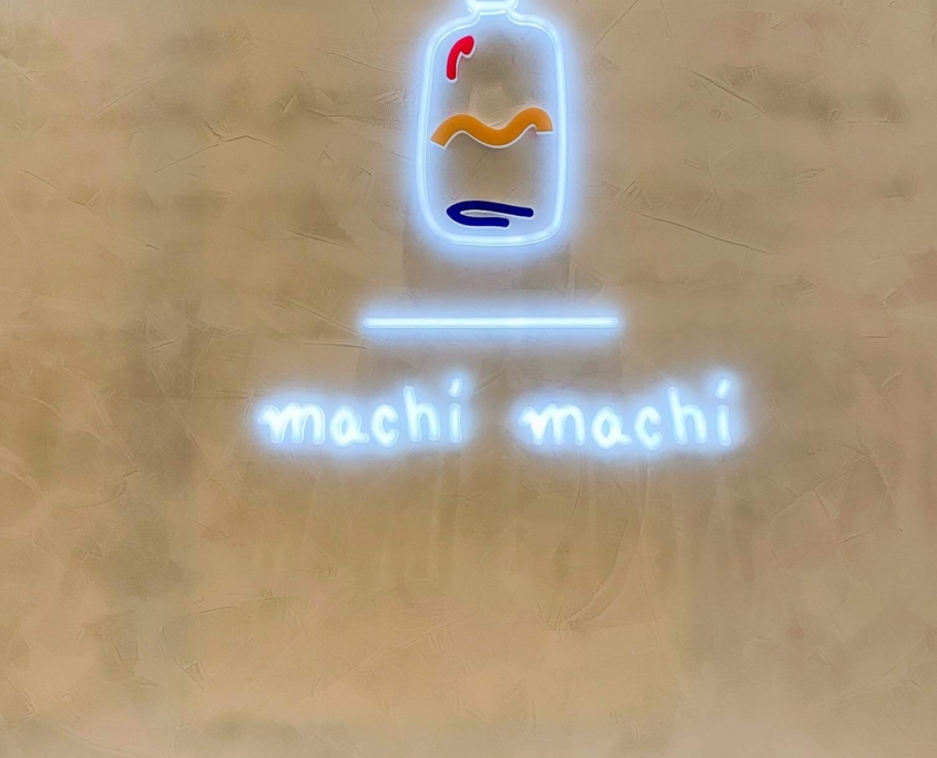 Machi Machi cute bottle neon sign on wall at Markham location