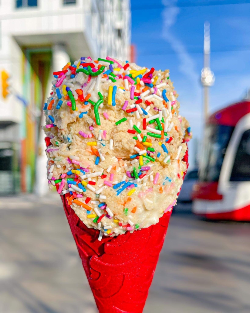 Pandoughra’s box birthday cake cookie dough in red ice cream cone with streetcar and CN Tower in background